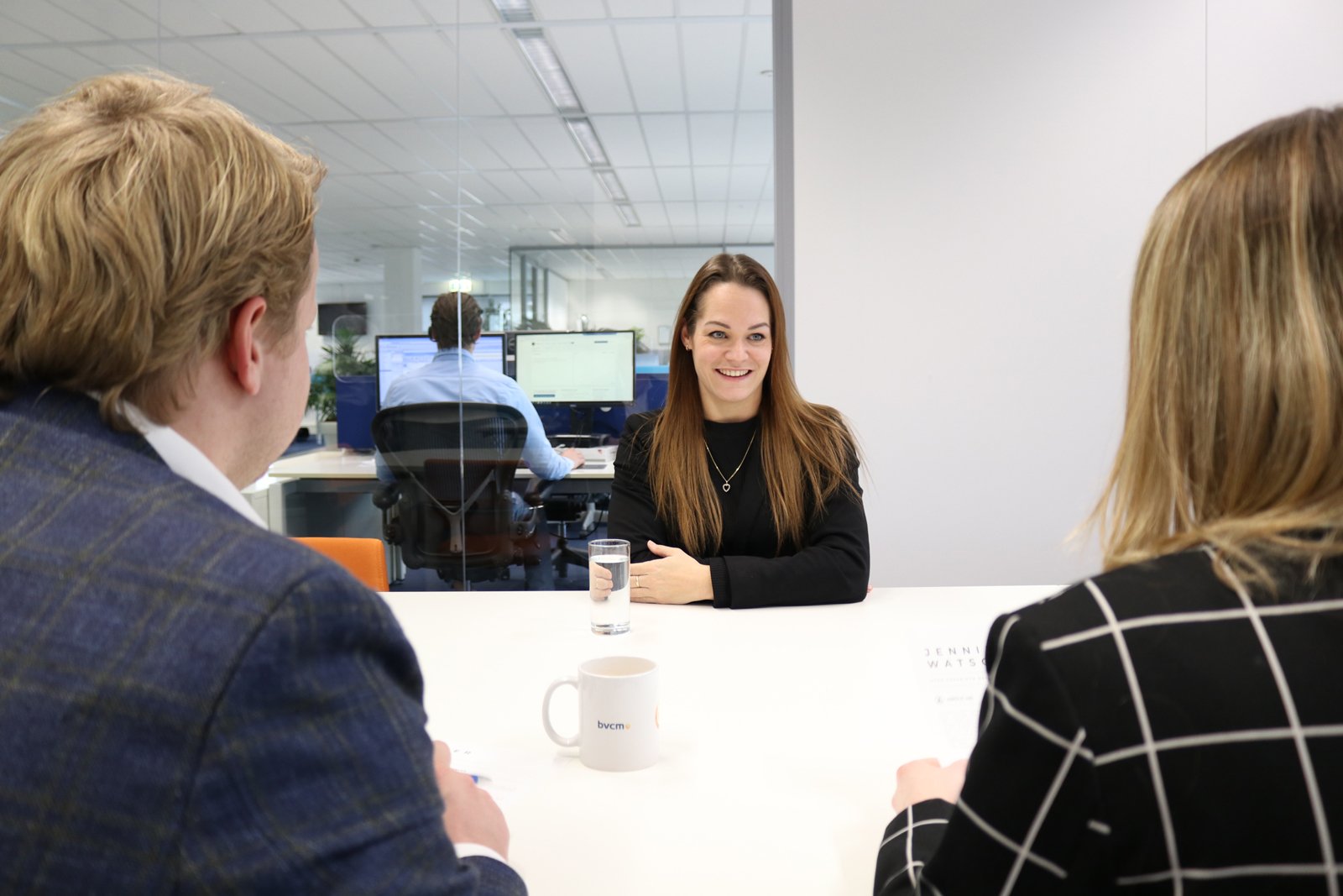 A job interview between 3 people, 1 of whom is the applicant. For recruitment and selection.
