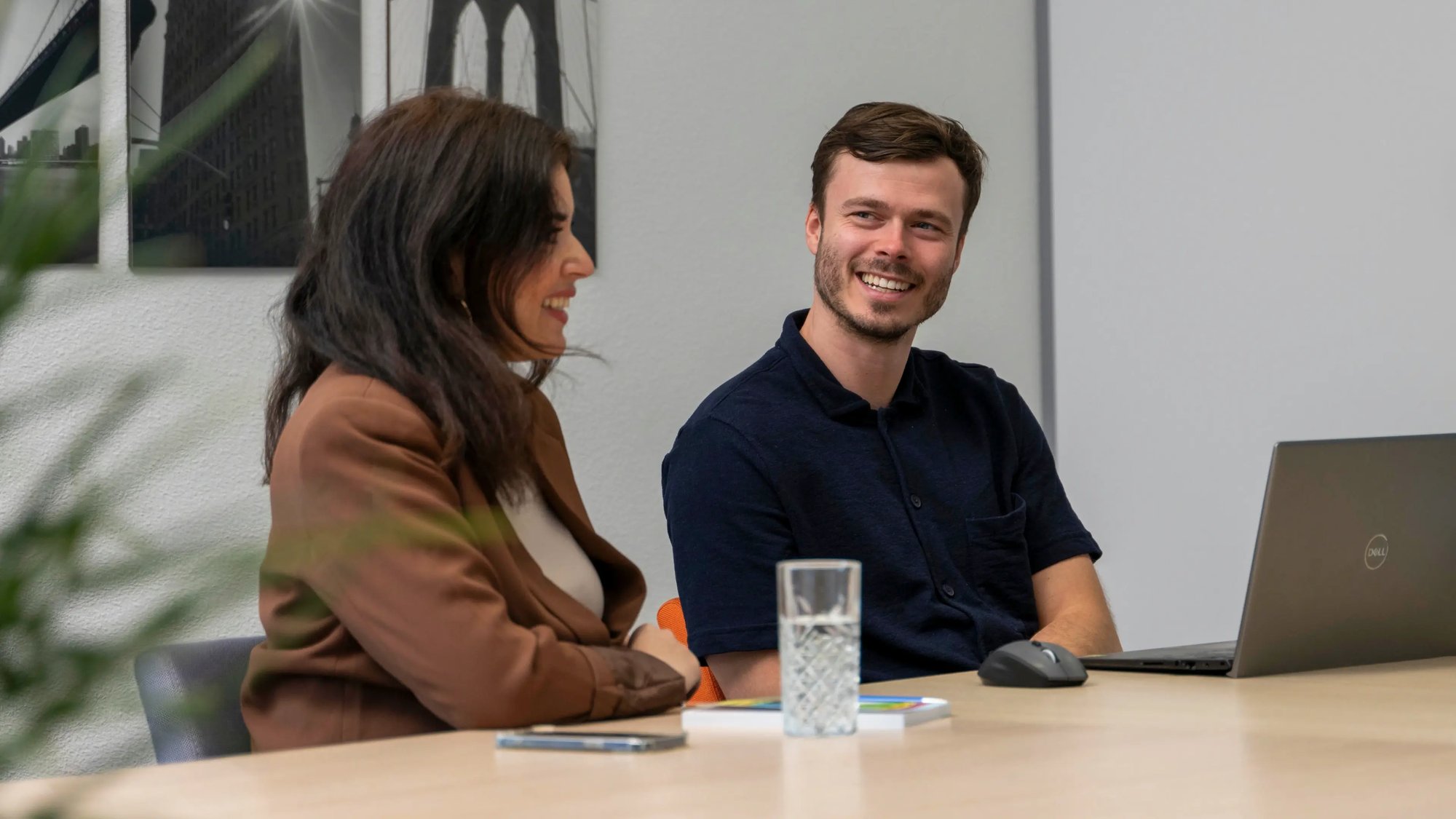 Two smiling people interacting to discuss posting opportunities.